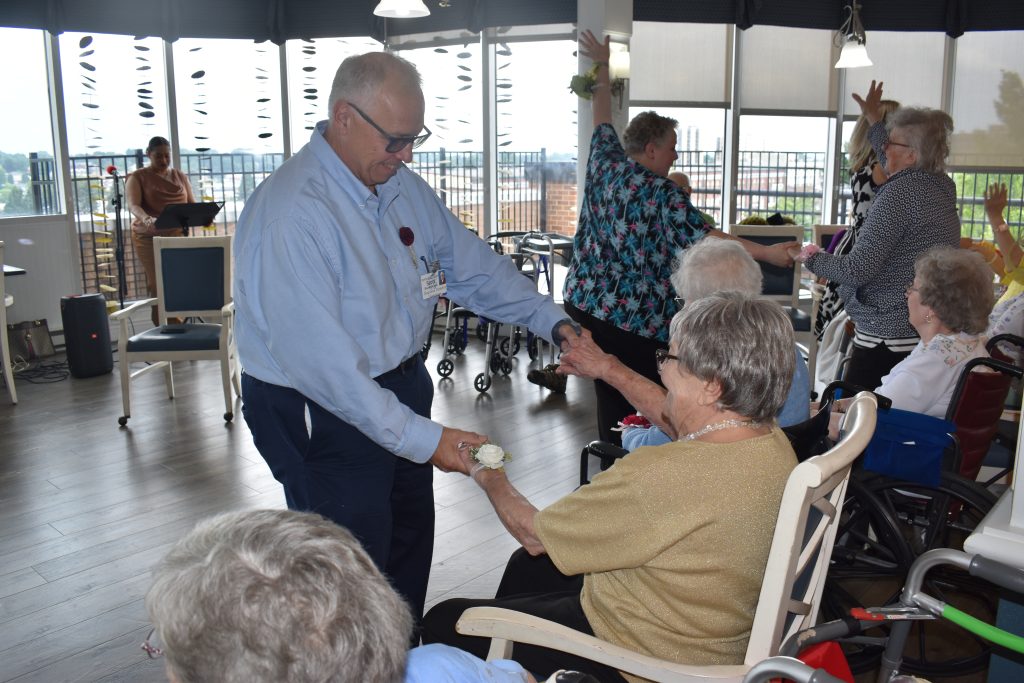 Rev. Dr. Scott Brooks-Cope dances with resident at Miller Personal Care at 19th & Chew.