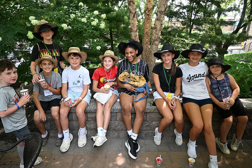 Camp Phoebe campers pose with a baby kangaroo on the Terrace patio.
