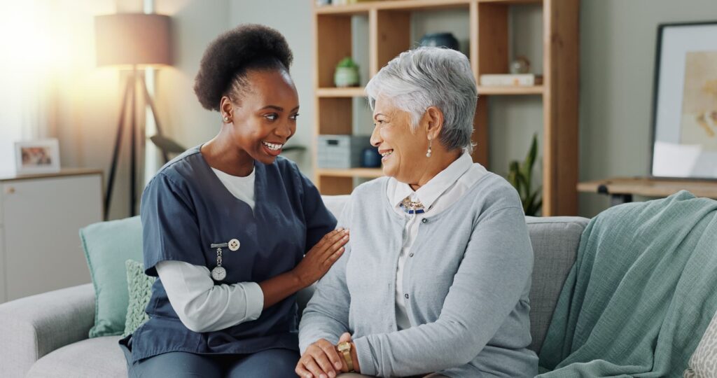 Elder women in nursing home talking to nurse.